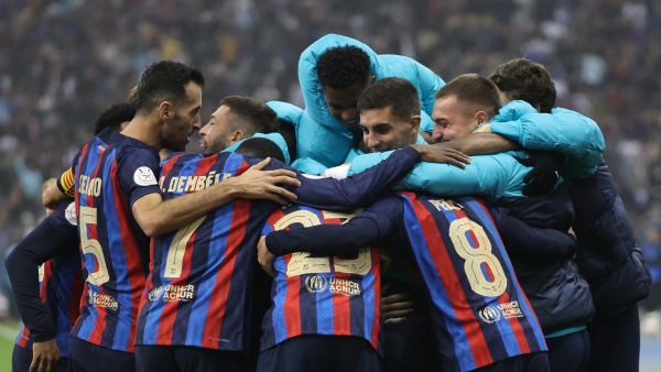 Barcelona's Spanish midfielder Pedri celebrates with teammates after scoring his team's third goal during the Spanish Super Cup final football match between Real Madrid CF and FC Barcelona at the King Fahd International Stadium in Riyadh, Saudi Arabia, on January 15, 2023. (Photo by Giuseppe CACACE / AFP)