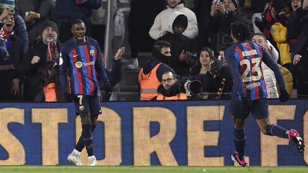 Barcelona's French forward Ousmane Dembele (L) celebrates scoring his team's first goal during the Copa del Rey (King's Cup), quarter final football match between FC Barcelona and Real Sociedad, at the Camp Nou stadium in Barcelona on January 25, 2023. (Photo by Josep LAGO / AFP)