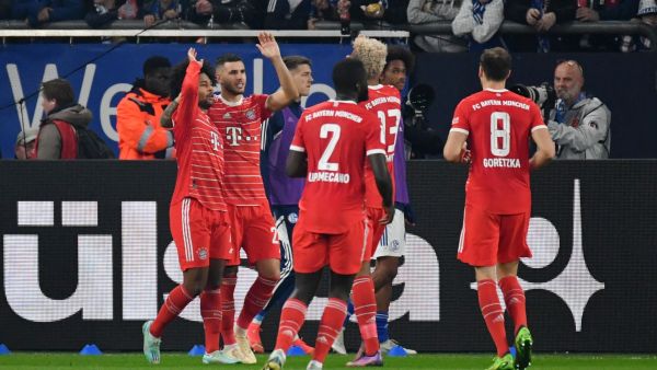 Bayern Munich's players celebrate after German midfielder Serge Gnabry (L) scored his team's first goal during the German first division Bundesliga football match between Schalke 04 v Bayern Munich in Gelsenkirchen, western Germany, on November 12, 2022. (Photo by UWE KRAFT / AFP) 