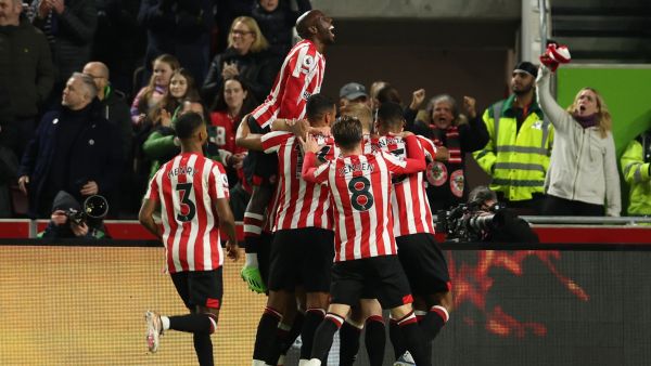Brentford players celebrate after an own goal from Liverpool's French defender Ibrahima Konate gives them the lead during the English Premier League football match between Brentford and Liverpool at Gtech Community Stadium in London on January 2, 2023. (Photo by Adrian DENNIS / AFP)