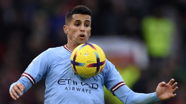 Manchester City's Portuguese defender Joao Cancelo controls the ball during the English Premier League football match between Manchester United and Manchester City at Old Trafford in Manchester, north west England, on January 14, 2023. (Photo by Oli SCARFF / AFP)