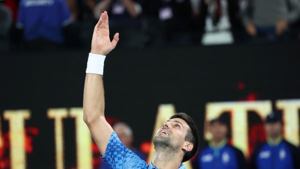 Serbia's Novak Djokovic celebrates victory in the men's singles final match against Greece's Stefanos Tsitsipas on day fourteen of the Australian Open tennis tournament in Melbourne on January 29, 2023. (Photo by DAVID GRAY / AFP)