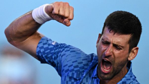 Serbia's Novak Djokovic celebrates his victory against Greece's Stefanos Tsitsipas during the men's singles final on day fourteen of the Australian Open tennis tournament in Melbourne on January 29, 2023. (Photo by ANTHONY WALLACE / AFP)