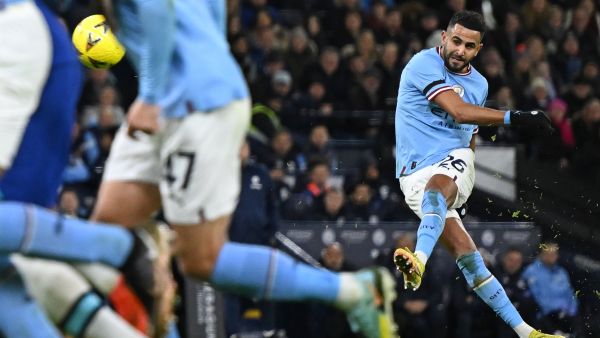 Manchester City's Algerian midfielder Riyad Mahrez scores the opening goal from this freekick during the English FA Cup third round football match between Manchester City and Chelsea at the Etihad Stadium in Manchester, north-west England, on January 8, 2023. (Photo by Oli SCARFF / AFP)
