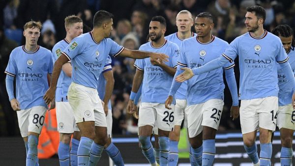 Manchester City's Algerian midfielder Riyad Mahrez (C) celebrates scoring the team's second goal during the English League Cup fourth round football match between Manchester City and Liverpool, at the Etihad stadium in Manchester on December 22, 2022. (Photo by Oli SCARFF / AFP) 