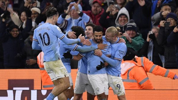 Manchester City's Algerian midfielder Riyad Mahrez (2R) celebrates scoring the team's third goal with Manchester City's Norwegian striker Erling Haaland (R) during the English Premier League football match between Manchester City and Tottenham Hotspur at the Etihad Stadium in Manchester, north west England, on January 19, 2023. (Photo by Oli SCARFF / AFP)