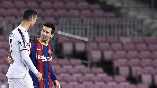 Portuguese forward Cristiano Ronaldo greets Argentinian forward Lionel Messi (R) before the UEFA Champions League group G football match between Barcelona and Juventus at the Camp Nou stadium in Barcelona on December 8, 2020. / AFP / Josep LAGO