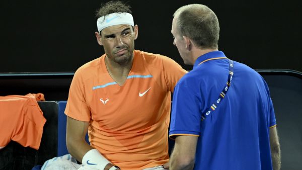 Spain's Rafael Nadal gets medical attention during the break in the men's singles match against Mackenzie McDonald of the US on day three of the Australian Open tennis tournament in Melbourne on January 18, 2023. (Photo by MANAN VATSYAYANA / AFP) 