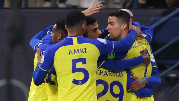 Nassr's Portuguese forward Cristiano Ronaldo celebrates with teammates after they scored their first goal during the Saudi Pro League football match between Al-Nassr and Al-Ettifaq at the King Fahd Stadium in the Saudi capital Riyadh on January 22, 2023. (Photo by Fayez NURELDINE / AFP)