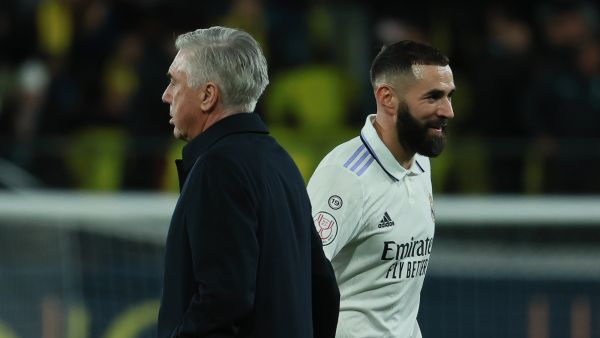 Real Madrid's Italian coach Carlo Ancelotti (L) and Real Madrid's French forward Karim Benzema react at the end of the Spain's Copa del Rey (King's Cup), round of 16 football match between Villarreal CF and Real Madrid CF at La Ceramica stadium in Vila-Real, near Valencia, on January 19, 2023. (Photo by JOSE JORDAN / AFP)
