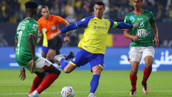 Nassr's Portuguese forward Cristiano Ronaldo (C) attempts a shot during the Saudi Pro League football match between Al-Nassr and Al-Ettifaq at the King Fahd Stadium in the Saudi capital Riyadh on January 22, 2023. (Photo by Fayez NURELDINE / AFP)