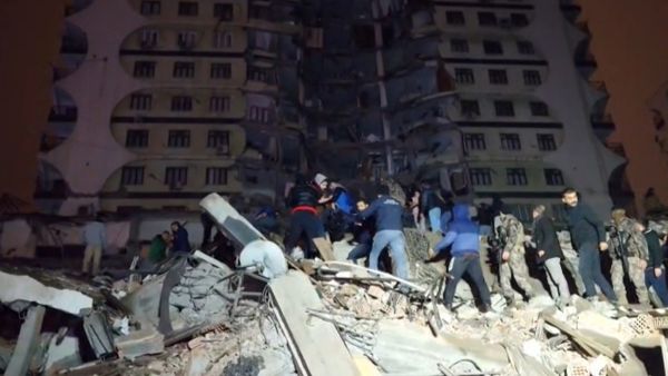 In this video grab from AFP TV taken on February 6, 2023, rescuers search for victims of a 7.8-magnitude earthquake that hit Diyarbakir, in southeastern Turkey, levelling buildings across several cities and causing damages in neighbouring Syria. (Photo by Mahmut BOZARSLAN / AFPTV / AFP) Turkey earthquake