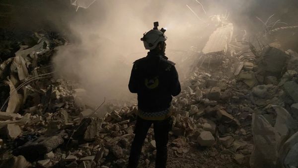 Graphic content / A member of the White Helmets civil defence rescue team stands in front of the rubble of a building during the search for survivors in the rebel-held Syrian town of Jindayris on February 8, 2023. (Photo by AFP) aid to Syria
