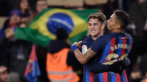Barcelona's Brazilian forward Raphinha (R) celebrates with Barcelona's Spanish midfielder Gavi after scoring his team's third goal during the Spanish league football match between FC Barcelona and Sevilla FC at the Camp Nou stadium in Barcelona, on February 5, 2023. (Photo by Josep LAGO / AFP)