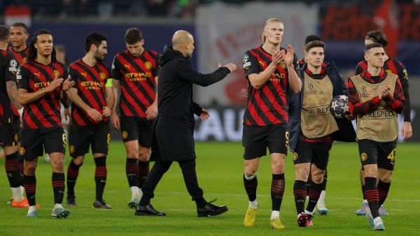 Manchester City's players including Norwegian striker Erling Haaland (C) and Manchester City's Spanish manager Pep Guardiola go over to their fans after the UEFA Champions League round of 16, first-leg football match between RB Leipzig and Manchester City in Leipzig, eastern Germany on February 22, 2023. (Photo by Odd ANDERSEN / AFP)