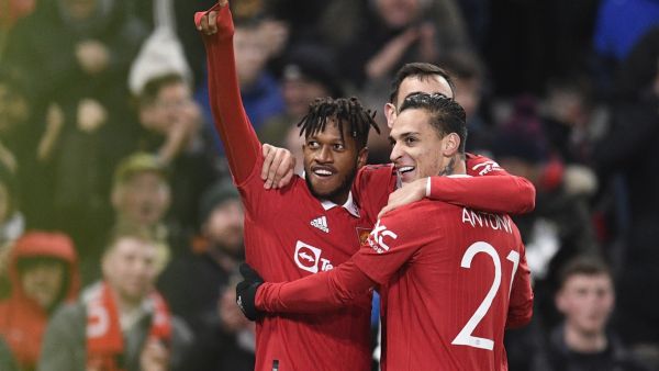 Manchester United's Brazilian midfielder Fred (L) celebrates with teammates after scoring their third goal during the English FA Cup fourth round football match between Manchester United and Reading at Old Trafford in Manchester, north west England, on January 28, 2023. (Photo by Oli SCARFF / AFP)
