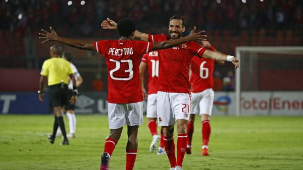 Ahly's forward Percy Tau (L) celebrates with Ahly's defender Ali Maaloul after scoring the fourth goal during the CAF Champions League semi-final match between Egypt's al-Ahly and Algeria's ES Setif at the al-Salam stadium in Cairo on May 7, 2022. (Photo by Khaled DESOUKI / AFP)