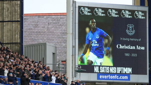 Supporters observe a minute's applause for former Everton player Christian Atsu, who died in the Turkey earthquake last week, ahead of the English Premier League football match between Everton and Leeds United at Goodison Park in Liverpool, north west England on February 18, 2023. (Photo by Lindsey Parnaby / AFP) 