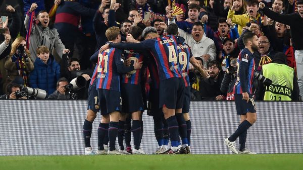 Barcelona's Brazilian forward Raphinha celebrates with teammates after scoring his team's second goal during the UEFA Europa League round of 32 first-leg football match between FC Barcelona and Manchester United at the Camp Nou stadium in Barcelona, on February 16, 2023. (Photo by Josep LAGO / AFP)