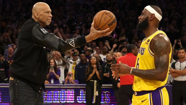 NBA Commissioner Adam Silver looks on as Kareem Abdul-Jabbar ceremoniously hands LeBron James #6 of the Los Angeles Lakers the ball after James passed Abdul-Jabbar to become the NBA's all-time leading scorer, surpassing Abdul-Jabbar's career total of 38,387 points against the Oklahoma City Thunder at Crypto.com Arena on February 07, 2023 in Los Angeles, California. (Photo by Harry How / GETTY IMAGES NORTH AMERICA / Getty Images via AFP)