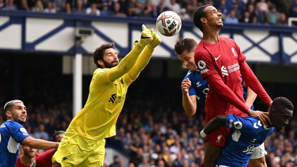 Liverpool's Brazilian goalkeeper Alisson Becker punches the ball clear during the English Premier League football match between Everton and Liverpool at Goodison Park in Liverpool, north west England on September 3, 2022. (Photo by Oli SCARFF / AFP) 