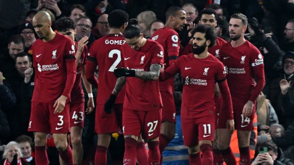 Liverpool's Egyptian striker Mohamed Salah (3R) celebrates scoring the opening goal during the English Premier League football match between Liverpool and Everton at Anfield in Liverpool, north west England on February 13, 2023. (Photo by Paul ELLIS / AFP)