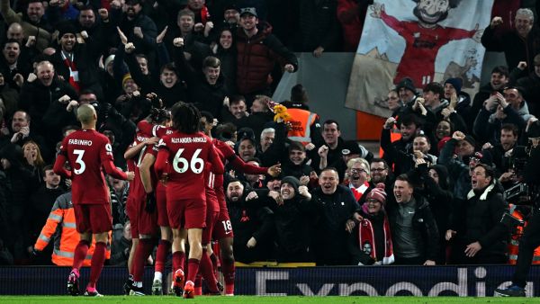 Liverpool's Egyptian striker Mohamed Salah is mobbed by teammates after scoring the opening goal during the English Premier League football match between Liverpool and Everton at Anfield in Liverpool, north west England on February 13, 2023. (Photo by Paul ELLIS / AFP)