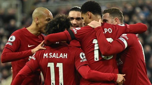 Liverpool's Dutch striker Cody Gakpo (C) celebrates after scoring his team second goal during the English Premier League football match between Newcastle United and Liverpool at St James' Park in Newcastle-upon-Tyne, north east England on February 18, 2023. (Photo by Oli SCARFF / AFP)