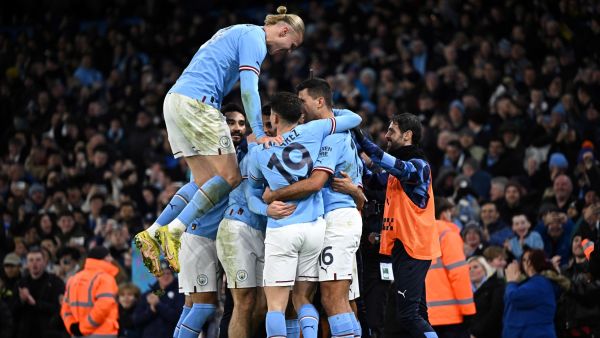 Manchester City's Norwegian striker Erling Haaland (L) jumps on teammates as they celebrate their opening goal by Manchester City's Dutch defender Nathan Ake during the English FA Cup fourth round football match between Manchester City and Arsenal at the Etihad Stadium in Manchester, northwest England, on January 27, 2023. (Photo by Oli SCARFF / AFP)