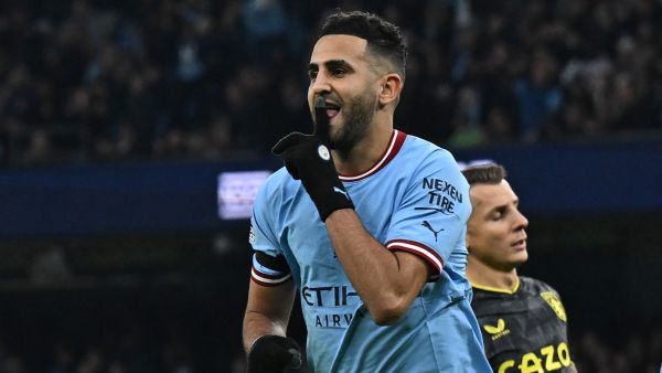 Manchester City's Algerian midfielder Riyad Mahrez celebrates after scoring their third goal from the penalty spot during the English Premier League football match between Manchester City and Aston Villa at the Etihad Stadium in Manchester, north west England, on February 12, 2023. (Photo by Paul ELLIS / AFP)