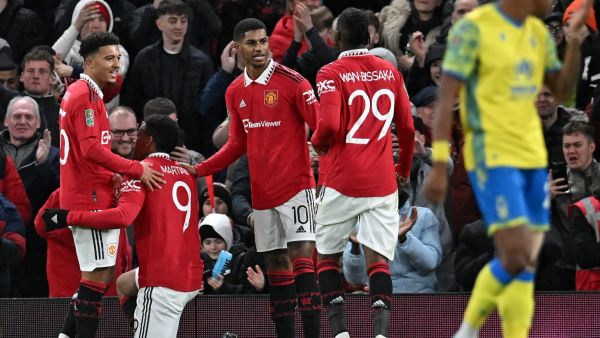 Manchester United's French striker Anthony Martial (2L) celebrates scoring the opening goal with Manchester United's English striker Jadon Sancho (L)during the English League Cup semi-final second-leg football match between Manchester United and Nottingham Forest at Old Trafford in Manchester, north west England, on February 1, 2023. (Photo by Paul ELLIS / AFP)