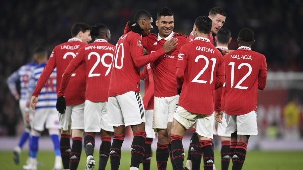 Manchester United's Brazilian midfielder Casemiro (C) celebrates with teammates after scoring their second goal during the English FA Cup fourth round football match between Manchester United and Reading at Old Trafford in Manchester, north west England, on January 28, 2023. (Photo by Oli SCARFF / AFP)