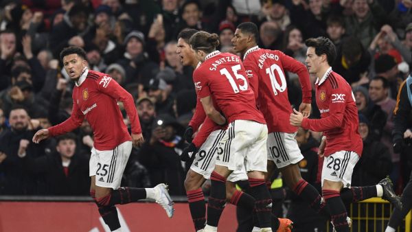 Manchester United's English striker Jadon Sancho (L) celebrates after scoring his team second goal during the English Premier League football match between Manchester United and Leeds United at Old Trafford in Manchester, north west England, on February 8, 2023. (Photo by Oli SCARFF / AFP)