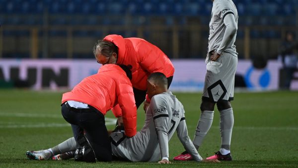 Paris Saint-Germain's French forward Kylian Mbappe receives medical assistance after getting injured during the French L1 football match between Montpellier Herault SC and Paris Saint-Germain (PSG) at Stade de la Mosson in Montpellier, southern France on February 1, 2023. (Photo by Sylvain THOMAS / AFP)