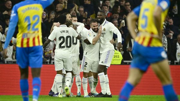 Real Madrid players celebrate their first goal scored by Real Madrid's Spanish midfielder Marco Asensio during the Spanish league football match between Real Madrid CF and Valencia CF at the Santiago Bernabeu stadium in Madrid on February 2, 2023. (Photo by JAVIER SORIANO / AFP)