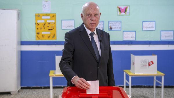 A handout picture provided by the press service of Tunisian presidency shows President Kais Saied casting his ballot at a polling station in the Ennasr district near Tunis on December 17, 2022, during the parliamentary election. (Photo by Tunisian Presidency / AFP) Kais Saied