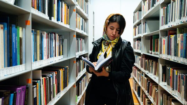 Afghan refugee and activist for women's rights Fatima Haidari reads a book at Bocconi University in Milan, Italy, on February 7, 2023.