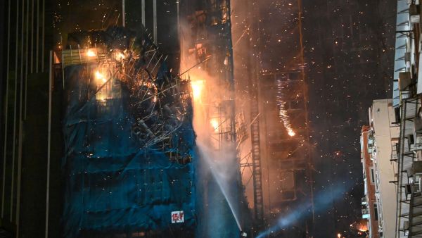 A fire burns at a high-rise building under construction in the Tsim Sha Tsui district in Hong Kong on March 3, 2023. (Photo by Peter PARKS / AFP) Hong Kong