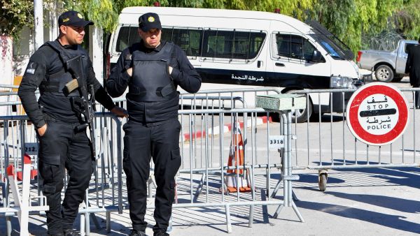 Members of the Tunisian police block the entrance to the Parliament as the new assembly holds its first session in Tunis, on March 13, 2023. (Photo by FETHI BELAID / AFP) new parliament