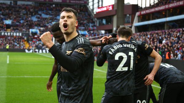 Arsenal's Brazilian midfielder Gabriel Martinelli (L) celebrates after a shot from Arsenal's Italian midfielder Jorginho ends up in the net, rebounding off Aston Villa's Argentinian goalkeeper Emiliano Martinez for an own-goal during the English Premier League football match between Aston Villa and Arsenal at Villa Park in Birmingham, central England on February 18, 2023. Arsenal won the game 4-2. (Photo by GEOFF CADDICK / AFP)