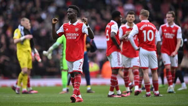 Arsenal's English midfielder Bukayo Saka gestures to fans on the pitch after the English Premier League football match between Arsenal and Crystal Palace at the Emirates Stadium in London on March 19, 2023. Arsenal won the game 4-1. (Photo by JUSTIN TALLIS / AFP)
