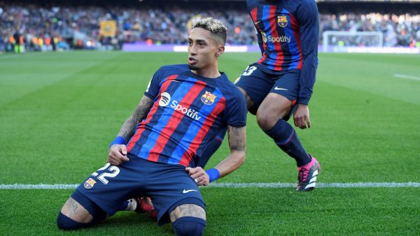Barcelona's Brazilian forward Raphinha (L) celebrates scoring his team's first goal with Barcelona's French defender Jules Kounde (R) during the Spanish League football match between FC Barcelona and Valencia CF at the Camp Nou stadium in Barcelona on March 5, 2023. (Photo by Josep LAGO / AFP)