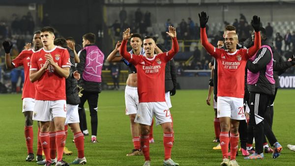 Benfica's players celebrate their victory at the end of the UEFA Champions League round of sixteen first leg football match between Bruges (Club Brugge) and Benfica Lisbon at Jan-Breydel Stadion in Bruges, on February 15, 2023. (Photo by JOHN THYS / AFP)