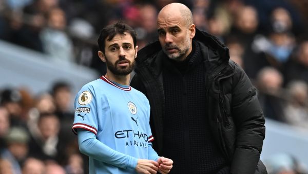 Manchester City's Spanish manager Pep Guardiola (R) speaks with Manchester City's Portuguese midfielder Bernardo Silva (L) before bringing him on as a substitute during the English Premier League football match between Manchester City and Newcastle United at the Etihad Stadium in Manchester, north west England, on March 4, 2023. (Photo by Paul ELLIS / AFP) 