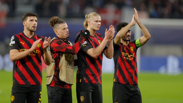 (L-R) Manchester City's Portuguese defender Ruben Dias, Manchester City's English midfielder Kalvin Phillips, Manchester City's Norwegian striker Erling Haaland and Manchester City's German midfielder Ilkay Gundogan applaud the fans after the UEFA Champions League round of 16, first-leg football match between RB Leipzig and Manchester City in Leipzig, eastern Germany on February 22, 2023. (Photo by Odd ANDERSEN / AFP)