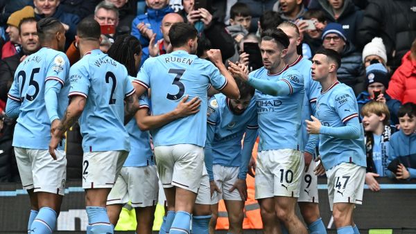 Manchester City's Portuguese midfielder Bernardo Silva (C) celebrates with teammates after scoring their second goal during the English Premier League football match between Manchester City and Newcastle United at the Etihad Stadium in Manchester, north west England, on March 4, 2023. (Photo by Paul ELLIS / AFP) 