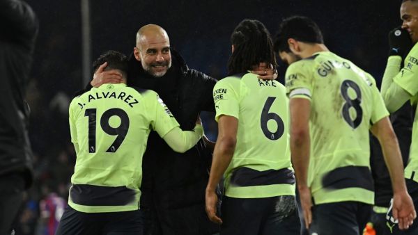 Manchester City's Spanish manager Pep Guardiola (L) celebrates with Manchester City's players after the English Premier League football match between Crystal Palace and Manchester City at Selhurst Park in south London on March 11, 2023. - Manchester City won the game 1-0. (Photo by Ben Stansall / AFP)