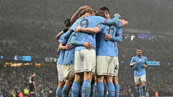 Manchester City's Norwegian striker Erling Haaland celebrates with teammates after scoring their second goal during the English FA Cup quarter-final football match between Manchester City and Burnley at the Etihad Stadium in Manchester, north-west England, on March 18, 2023. (Photo by Oli SCARFF / AFP)