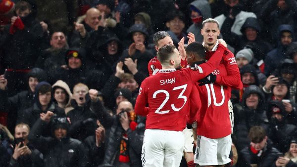 Manchester United's Brazilian midfielder Antony (R) celebrates with teammates after scoring their second goal during the UEFA Europa league round of 16 first leg football match between Manchester United and Real Betis at Old Trafford stadium in Manchester, north-west England, on March 9, 2023. (Photo by DARREN STAPLES / AFP)