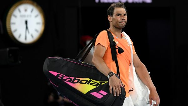 Spain's Rafael Nadal leaves the court after losing to USA's Mackenzie McDonald in their men's singles match on day three of the Australian Open tennis tournament in Melbourne on January 18, 2023. (Photo by MANAN VATSYAYANA / AFP)